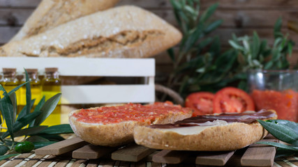 Spanish and Andalusian breakfast, toasted bread with oil, serrano ham and crushed tomato.