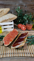 Spanish and Andalusian breakfast, toasted bread with oil, serrano ham and crushed tomato.