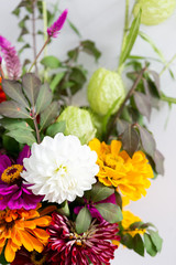 Naklejka na ściany i meble Close up of colorful flower bouquet, white dahlia flower, milkweed, and orange and purple daisies