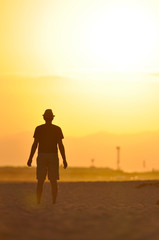 Fototapeta na wymiar Silhouette of a man meditating at sunset.