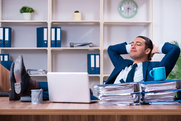 Young handsome businessman working in the office