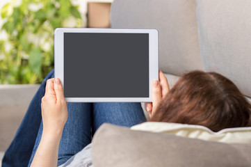  woman using a tablet and showing a blank screen