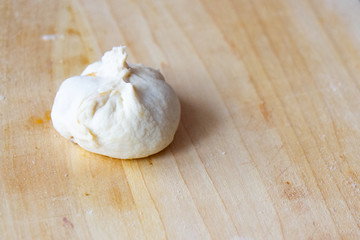 preparation of a dough for baking on a chopping board - preparing Slovakian steamed buns