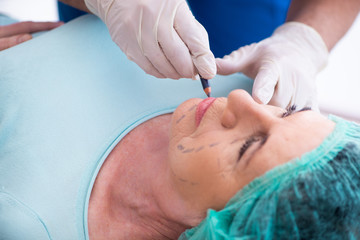 Old woman visiting male doctor for plastic surgery