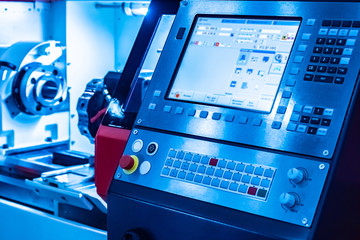 Machine with numerical control. Robotic production. Display screen for setting production parameters. Industrial concept in blue.