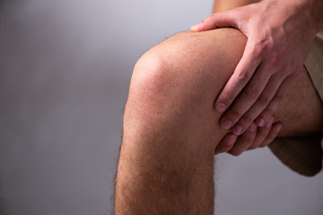 Young man suffering from leg pain