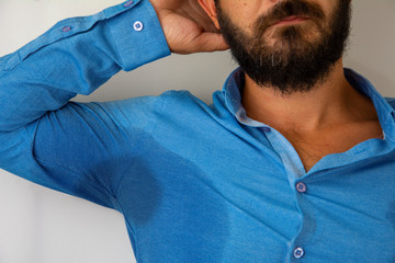Armpit sweaty man in blue shirt