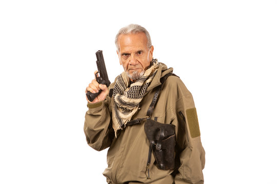 Gun drawn, mature survivalist wearing a shemagh.
