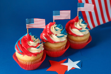 Tasty patriotic cupcakes on color background