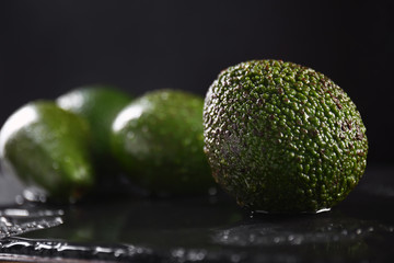 Ripe avocados on dark table