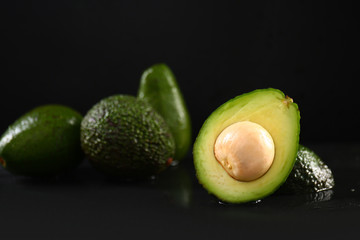 Ripe avocados on dark table