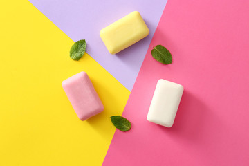 Different soap bars on color background