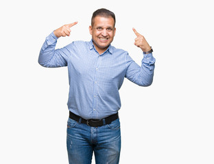 Fototapeta premium Middle age arab business man over isolated background Smiling pointing to head with both hands finger, great idea or thought, good memory