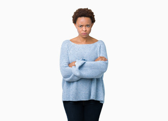 Young beautiful african american woman wearing a sweater over isolated background skeptic and...
