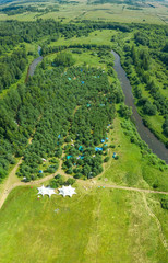 Aerial view of a star-shaped tent on a green field