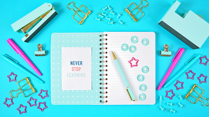 Back to school concept with blue theme notebook with stationery flatlay overhead..