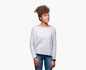 Beautiful young african american woman over isolated background smiling looking side and staring away thinking.