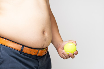 belly of a Japanese fat man holding a tennis ball