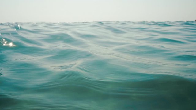 Underwater, sea waves with sunrays shining through the water