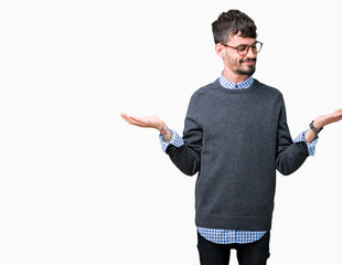 Young handsome smart man wearing glasses over isolated background Smiling showing both hands open...