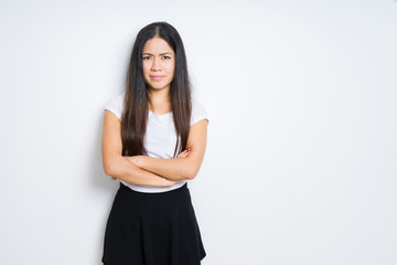 Fototapeta premium Beautiful brunette woman over isolated background skeptic and nervous, disapproving expression on face with crossed arms. Negative person.