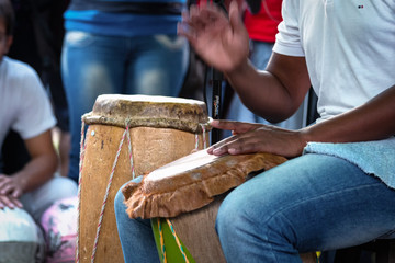 Drum player playing atabaque during presentation of afro music in a festival