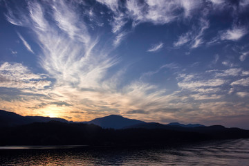 sunset in the mountains as viewed from a cruise ship