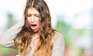 Young beautiful woman wearing winter dress Looking at the watch time worried, afraid of getting late