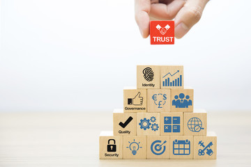 Business Concept for Leadership, Teamwork, Strategy and trust icons on Wood Blocks Concept..