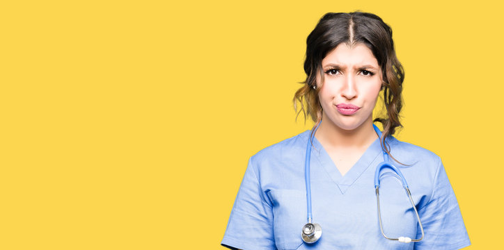 Young adult doctor woman wearing medical uniform depressed and worry for distress, crying angry and afraid. Sad expression.