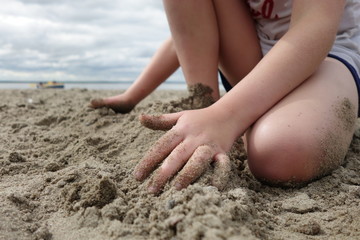 Fototapeta na wymiar Child playing on a sandy beach