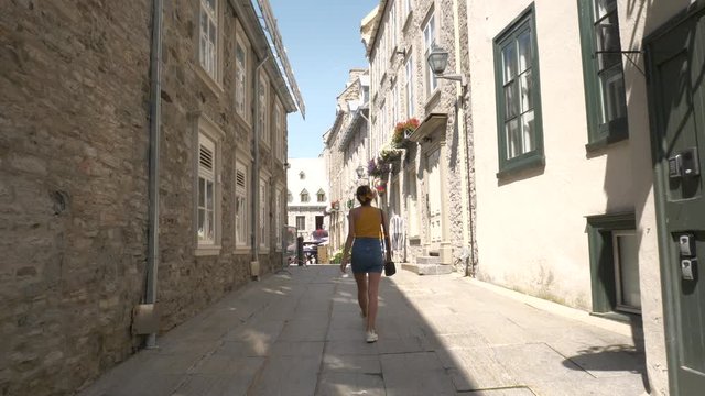 Woman Walking Through Old Town Streets On Vacation, Quebec