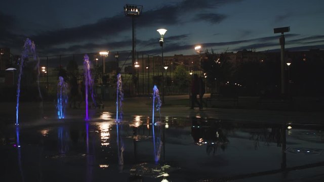 Colorful fountains in the downtown park an night