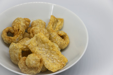 Crispy pork crackers. Thai food or snack made from pork skin, seasoned with salt or soy sauce and Fried with hot oil until crispy.