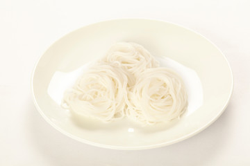 Thai fermented rice flour noodle (Khanom chin) on white plate.
