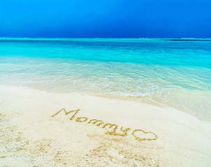 Fototapeta na wymiar Beautiful sunny beach by the blue sea. Inscription