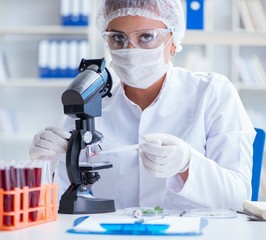 Female scientist researcher conducting an experiment in a labora