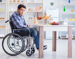 Disabled young man husband working in kitchen