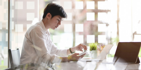 Young businessman working on his project with laptop