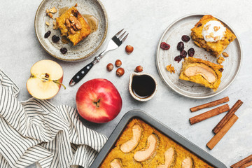 Apple cake and pumpkin spice cake on grey background. Homemade autumn cake. Top view