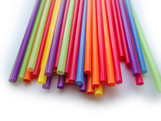 background of colorful tubes for cocktails laid out at the top of the frame