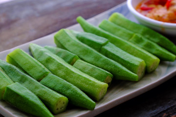 rectangle plate boiled okra with tofu cheese on wooden background