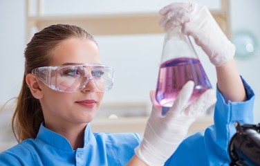Female scientist researcher conducting an experiment in a labora