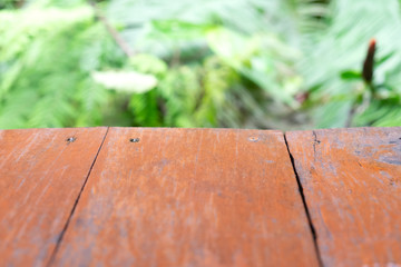 Empty old wood table with backdrop blur nature garden field background, for display your product and copy space.