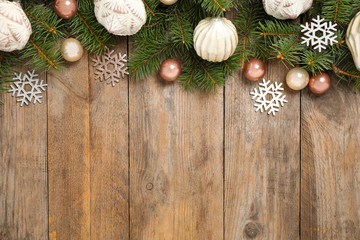 Fir branches with Christmas decoration on wooden background, flat lay. Space for text