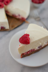 Cheesecake slice with raspberries on a plate