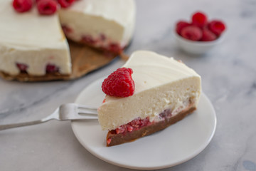 Cheesecake slice with raspberries on a plate