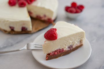 Cheesecake slice with raspberries on a plate