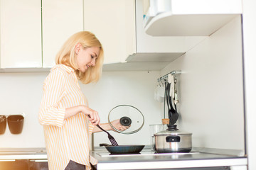 Blonde woman preparing dinner