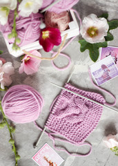 Handmade crochet work and crochet hook with ball of yarn, woman hobby gray background